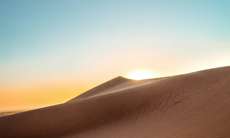 A sand dune at sunrise