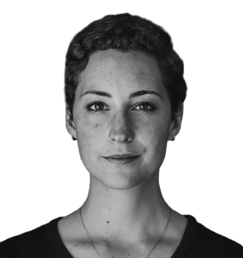 A black-and-white portrait of a woman with short curly hair