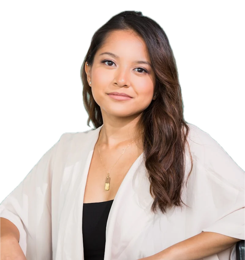 A woman with long dark hair in a cream cardigan