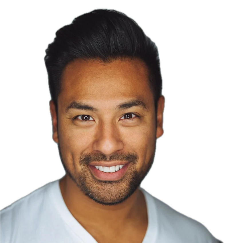 A smiling man with short dark hair in a white V-neck shirt
