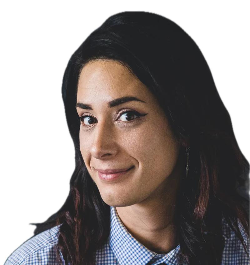 A woman with long dark hair in a checked shirt, looking at the camera